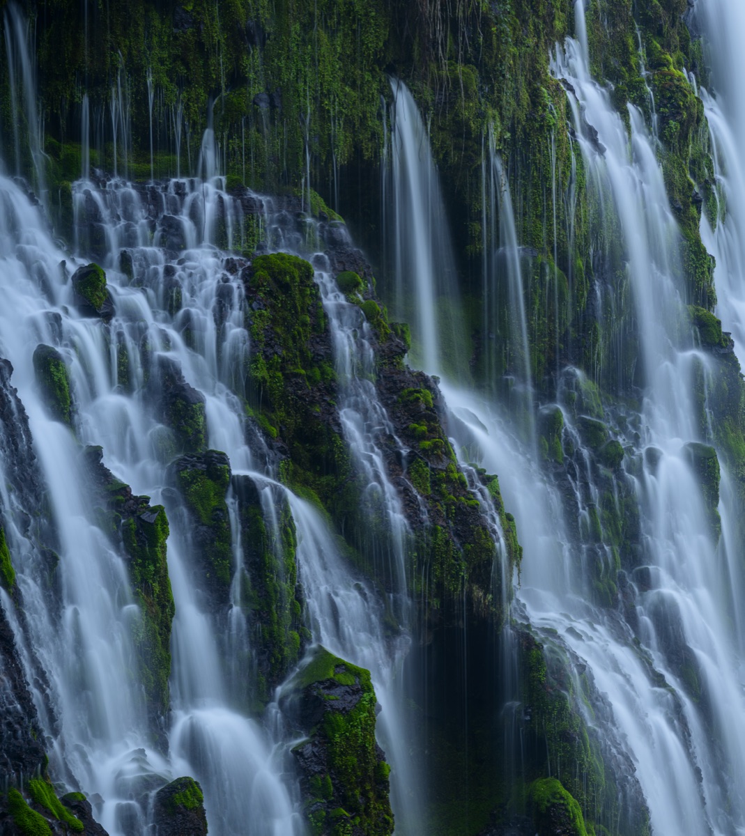 Burney Falls pouring over mossy cliffs after days of rain
