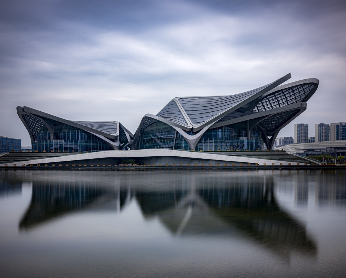 A butterfly-shaped art center reflected in a lake in Zhuhai
